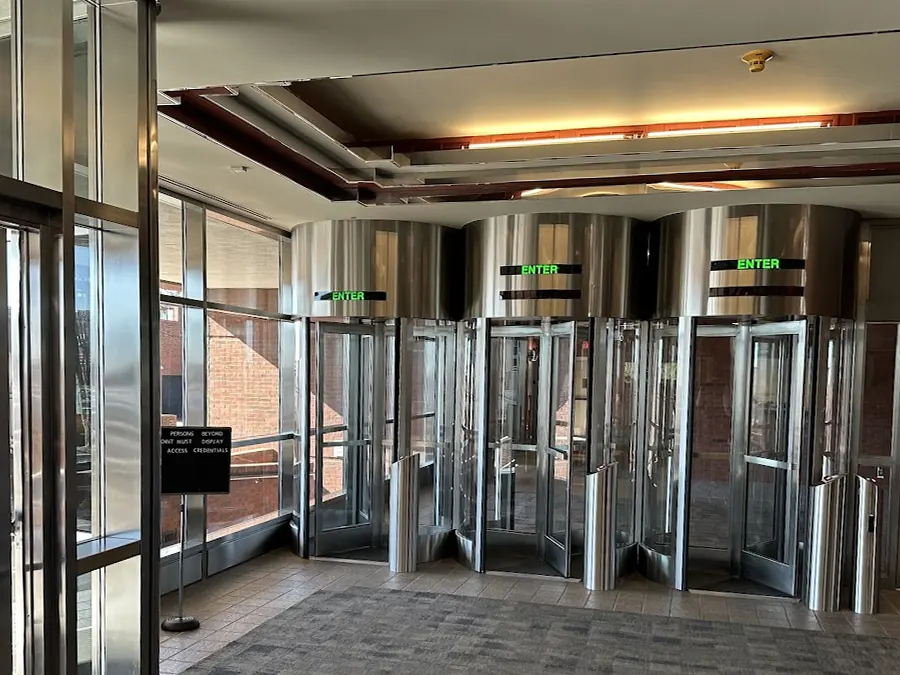 Lobby security turnstiles in the main building requiring displayed access credentials