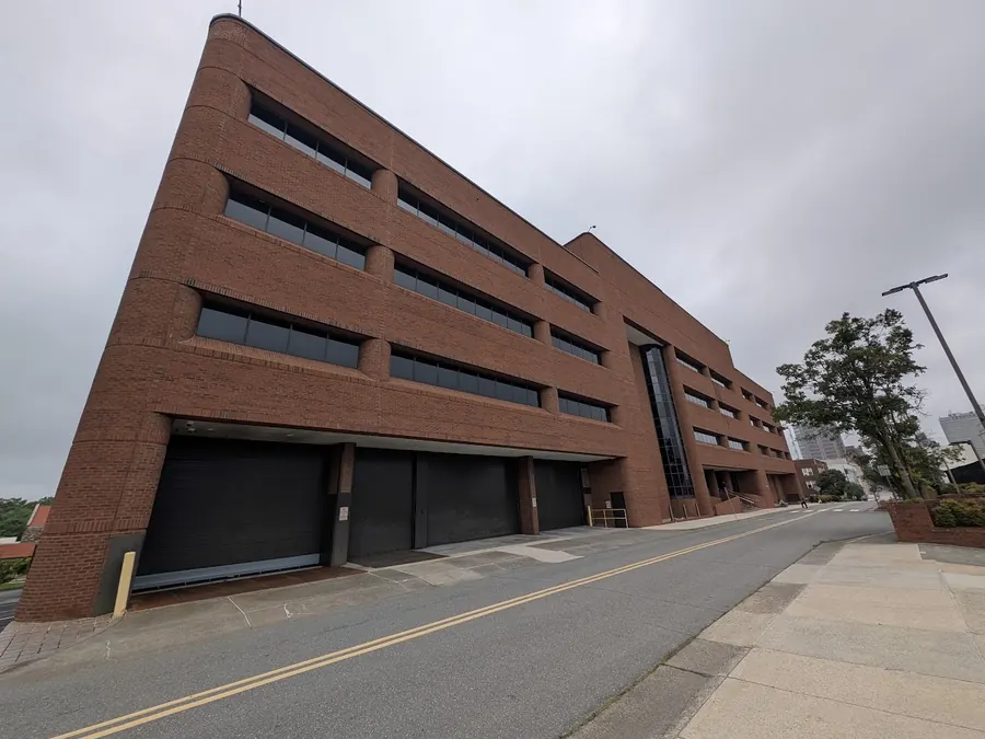 Three roll-up loading bay doors on the southwest corner of the main building