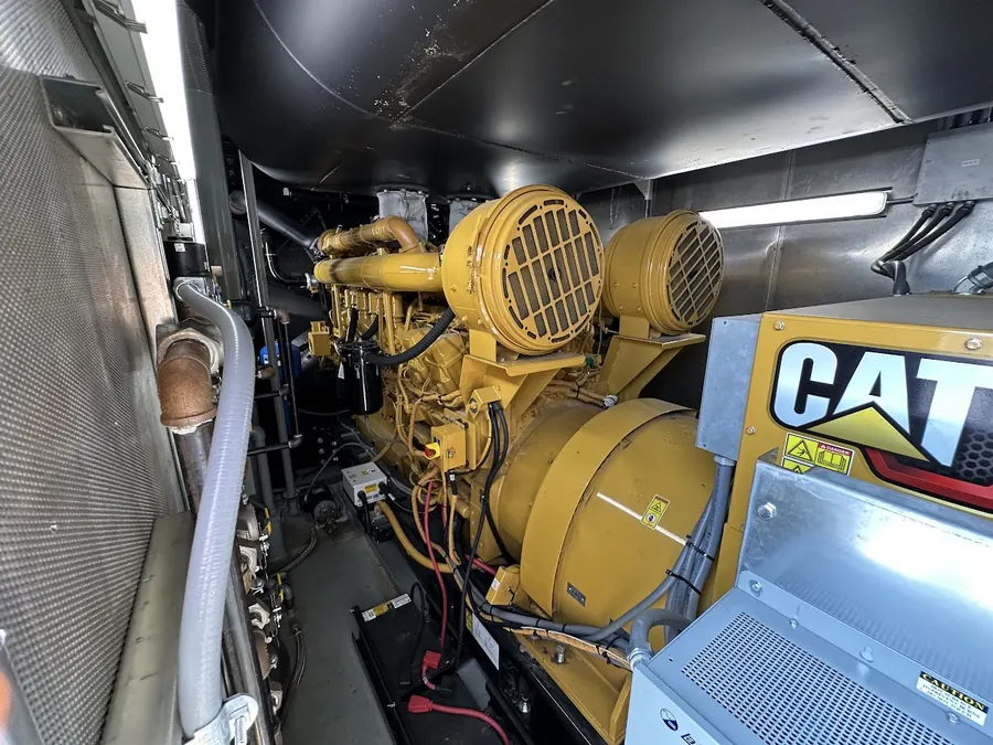 Caterpillar diesel generator set installed inside a walk-in enclosure