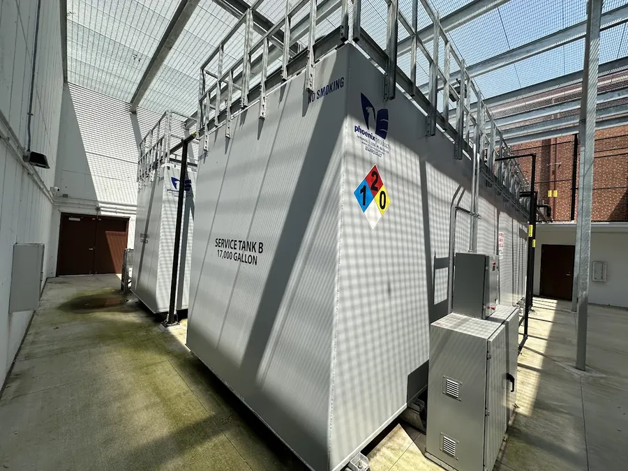 Two 17,000 gallon diesel service tanks under a screened enclosure