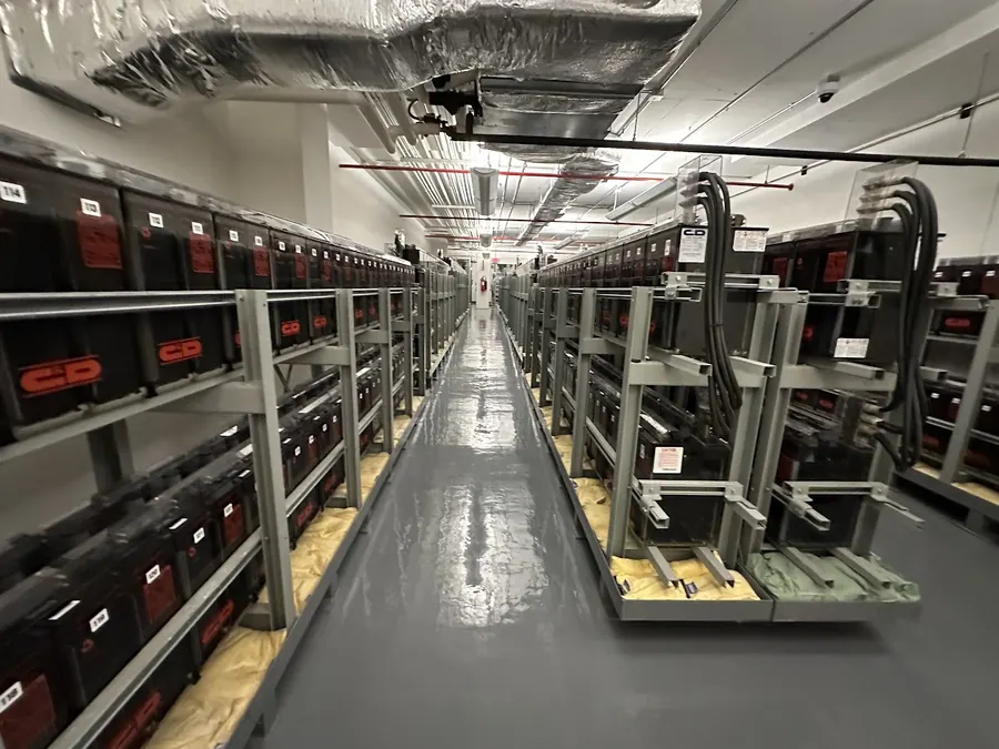 Rows of C and D battery strings on racks in the battery room
