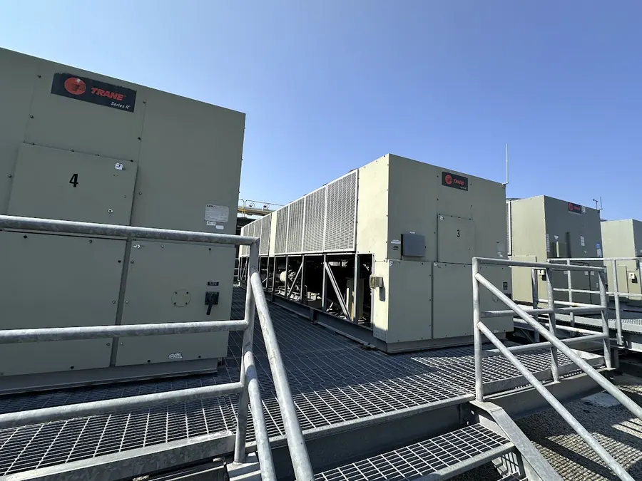 Numbered Trane air-cooled chillers on the roof deck walkway